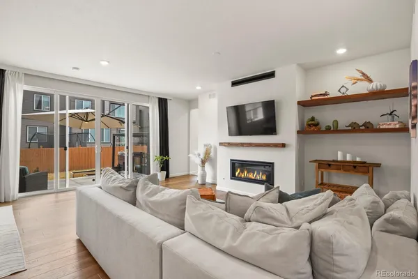 a living room with furniture a fireplace and a flat screen tv