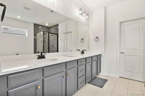 a bathroom with a sink double vanity and a mirror