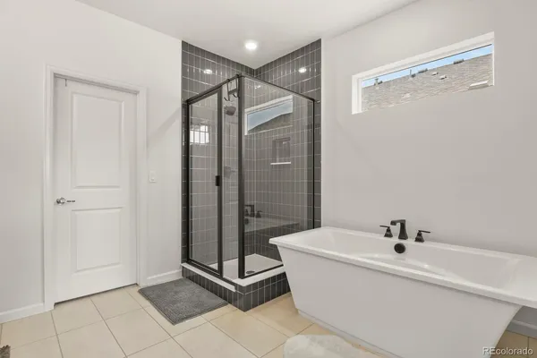 a bathroom with a bathtub and shower