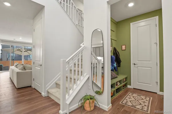 a view of entryway and hall with wooden floor