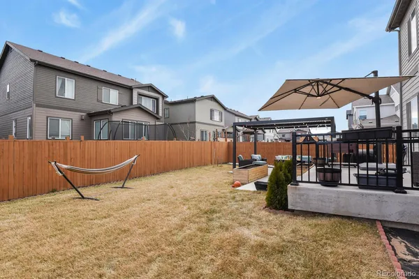 a backyard of a house with barbeque oven table and chairs