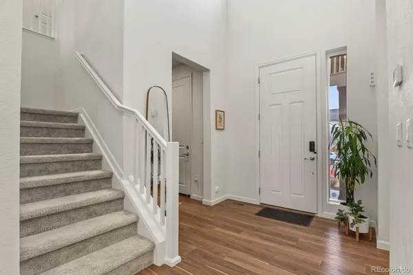 a view of entryway with wooden floor and stairs