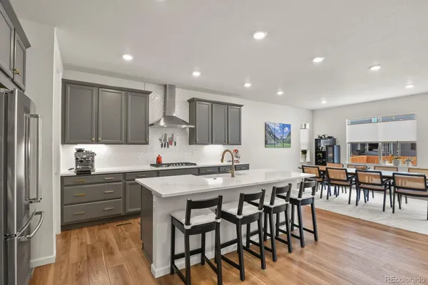 a kitchen with cabinets table and chairs