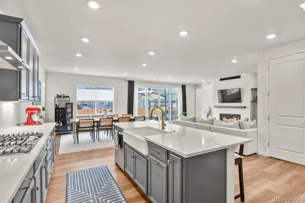a kitchen with sink refrigerator and cabinets