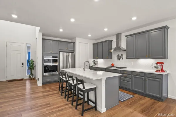 a kitchen with stainless steel appliances granite countertop a sink counter space and cabinets
