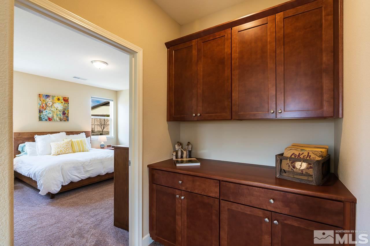 10155 Toltec Court Reno, NV 89521 - Photo 7 of 19 a bedroom with a bed and cabinets