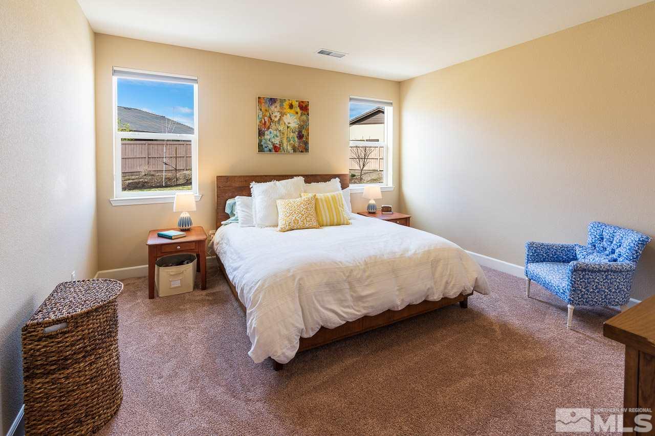 10155 Toltec Court Reno, NV 89521 - Photo 8 of 19 a bedroom with a bed and a painting on the wall