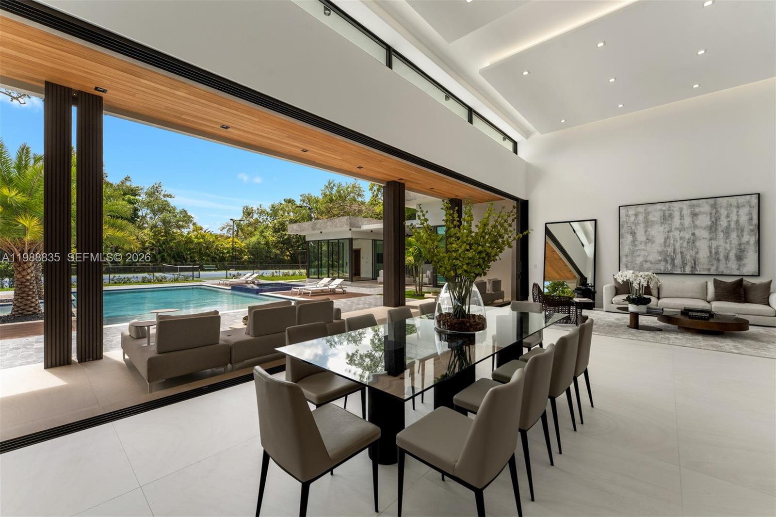 9790 Southwest 114th Street Miami, FL 33176 - Photo 11 of 47 a living room with patio furniture and a floor to ceiling window