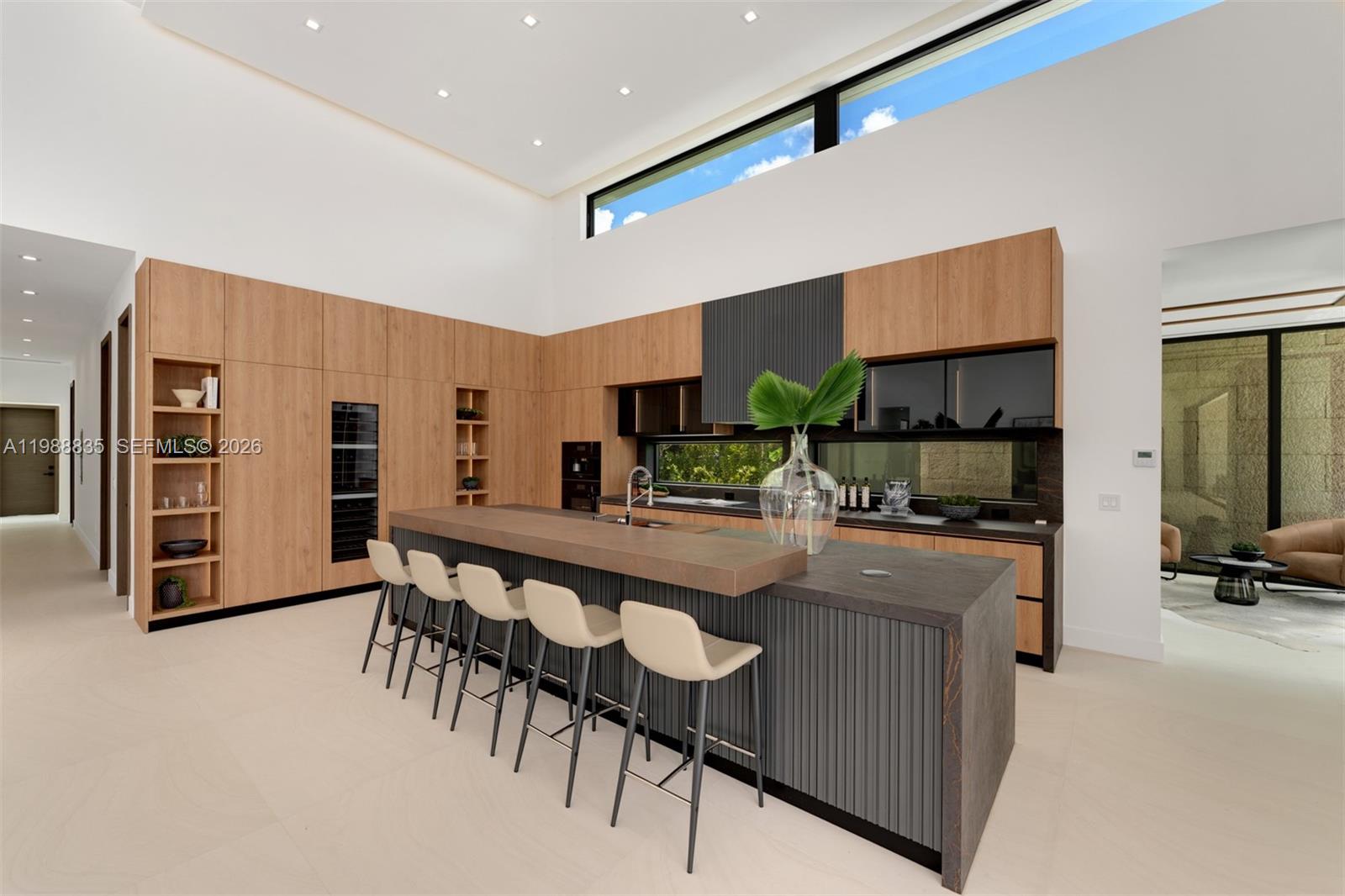 9790 Southwest 114th Street Miami, FL 33176 - Photo 12 of 47 a large kitchen with kitchen island a dining table and chairs