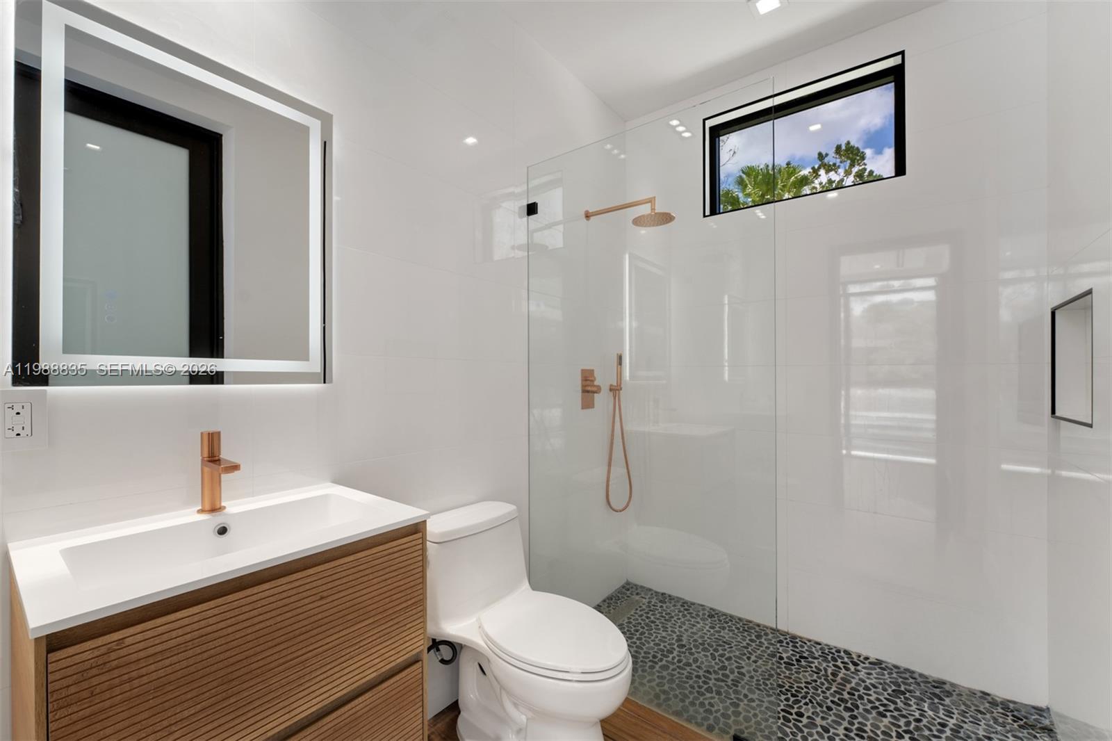 9790 Southwest 114th Street Miami, FL 33176 - Photo 26 of 47 a bathroom with a toilet a sink and mirror