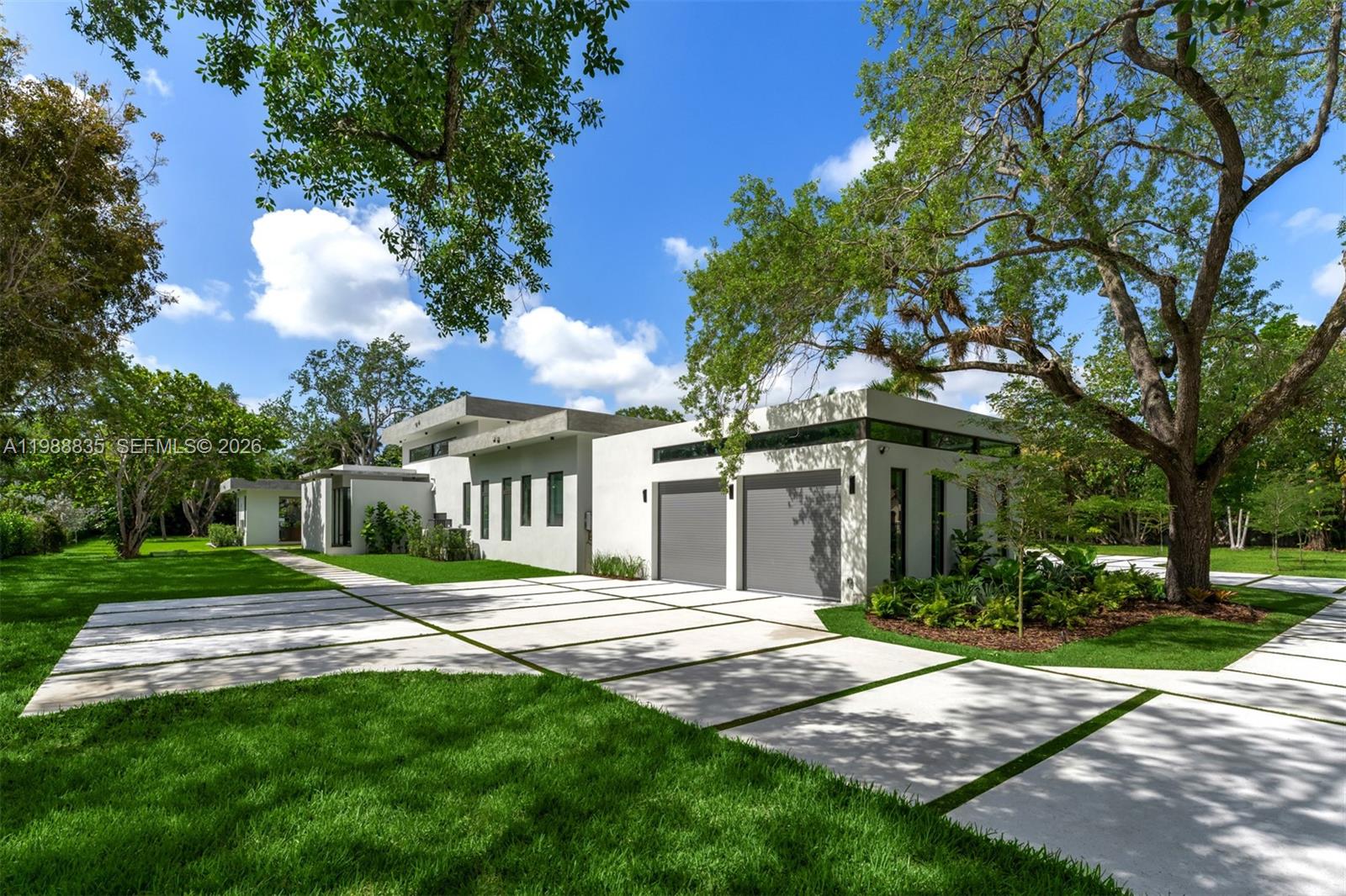 9790 Southwest 114th Street Miami, FL 33176 - Photo 35 of 47 a front view of a house with a yard and trees