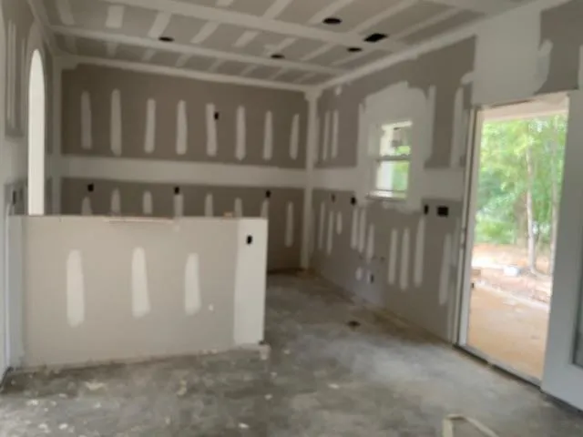 a view of a porch with wooden floor and a window