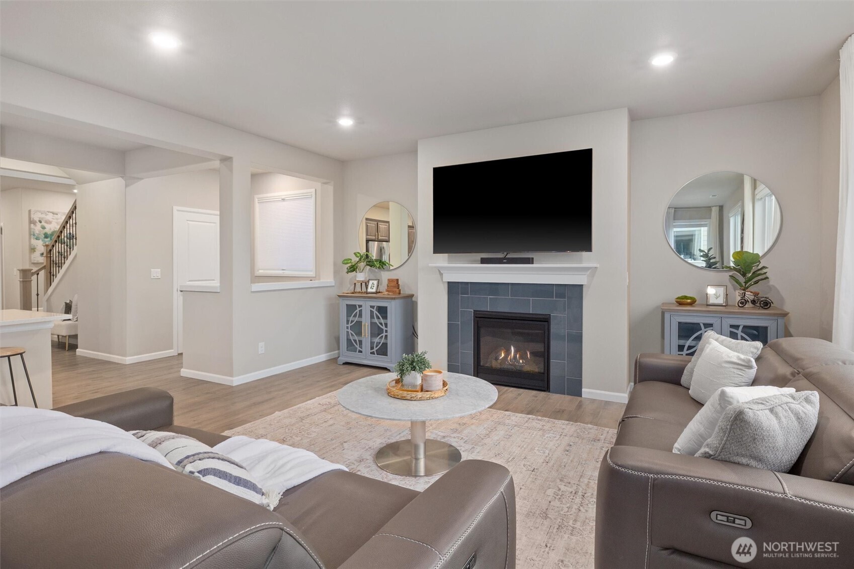 23718 43rd Drive Southeast Bothell, WA 98021 - Photo 18 of 40 a living room with furniture a flat screen tv and a fireplace