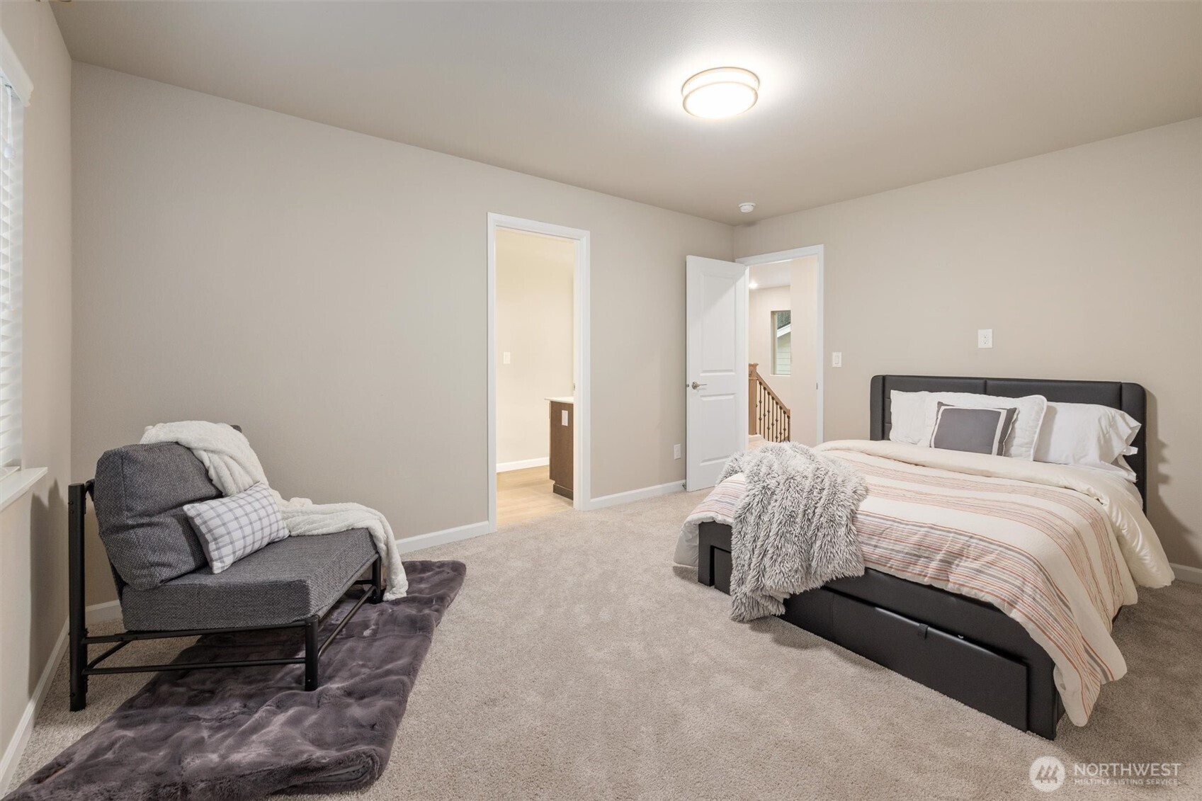 23718 43rd Drive Southeast Bothell, WA 98021 - Photo 25 of 40 a bedroom with a bed and a chair