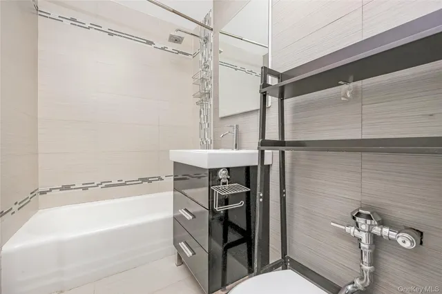 a bathroom with a shower toilet and tub