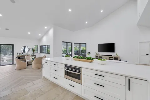 a kitchen with stainless steel appliances a sink stove and cabinets