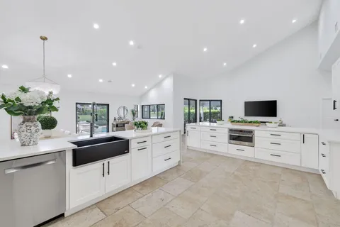a kitchen with stainless steel appliances white cabinets and a stove