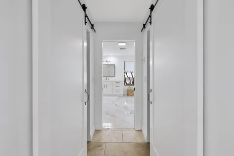 a view of a bathroom from a hallway