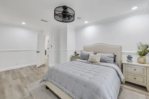 a bedroom with a bed and a chandelier