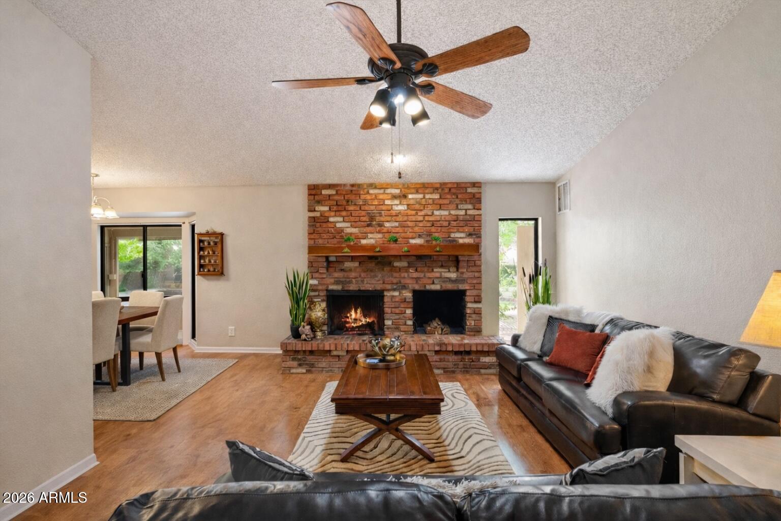 a living room with furniture a fireplace and a chandelier
