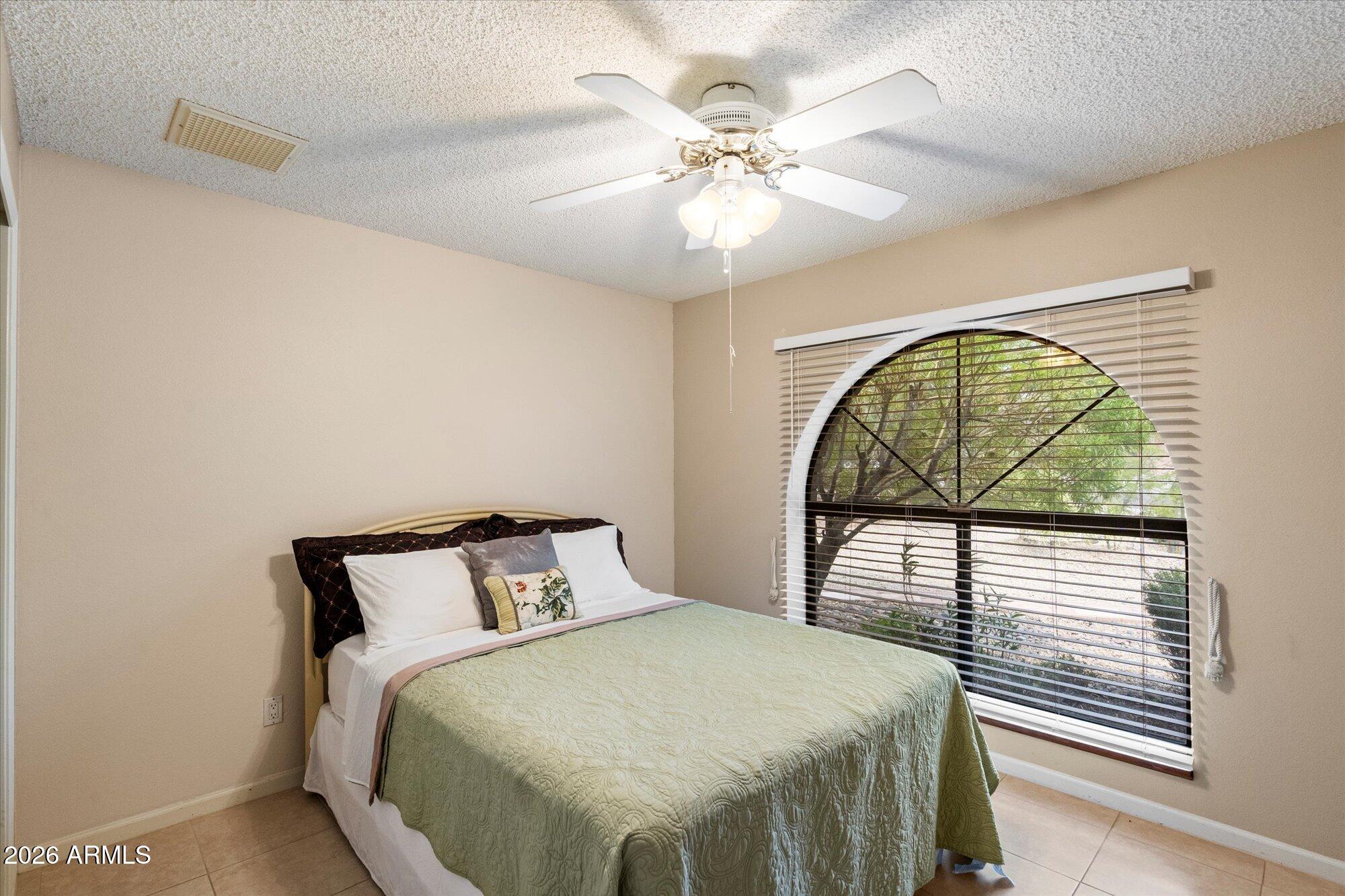 14242 North 9th Street Phoenix, AZ 85022 - Photo 12 of 26 a bedroom with a bed and a window