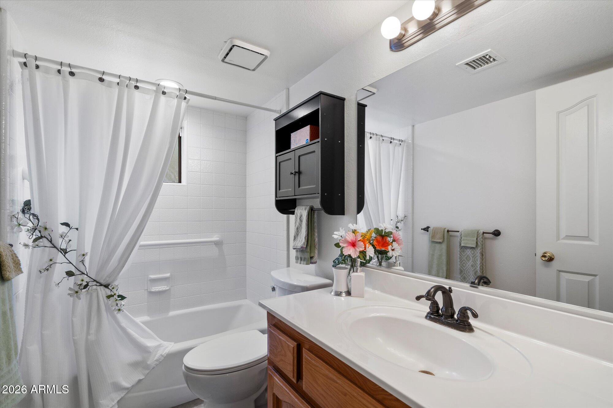 14242 North 9th Street Phoenix, AZ 85022 - Photo 14 of 26 a bathroom with a sink a toilet and shower