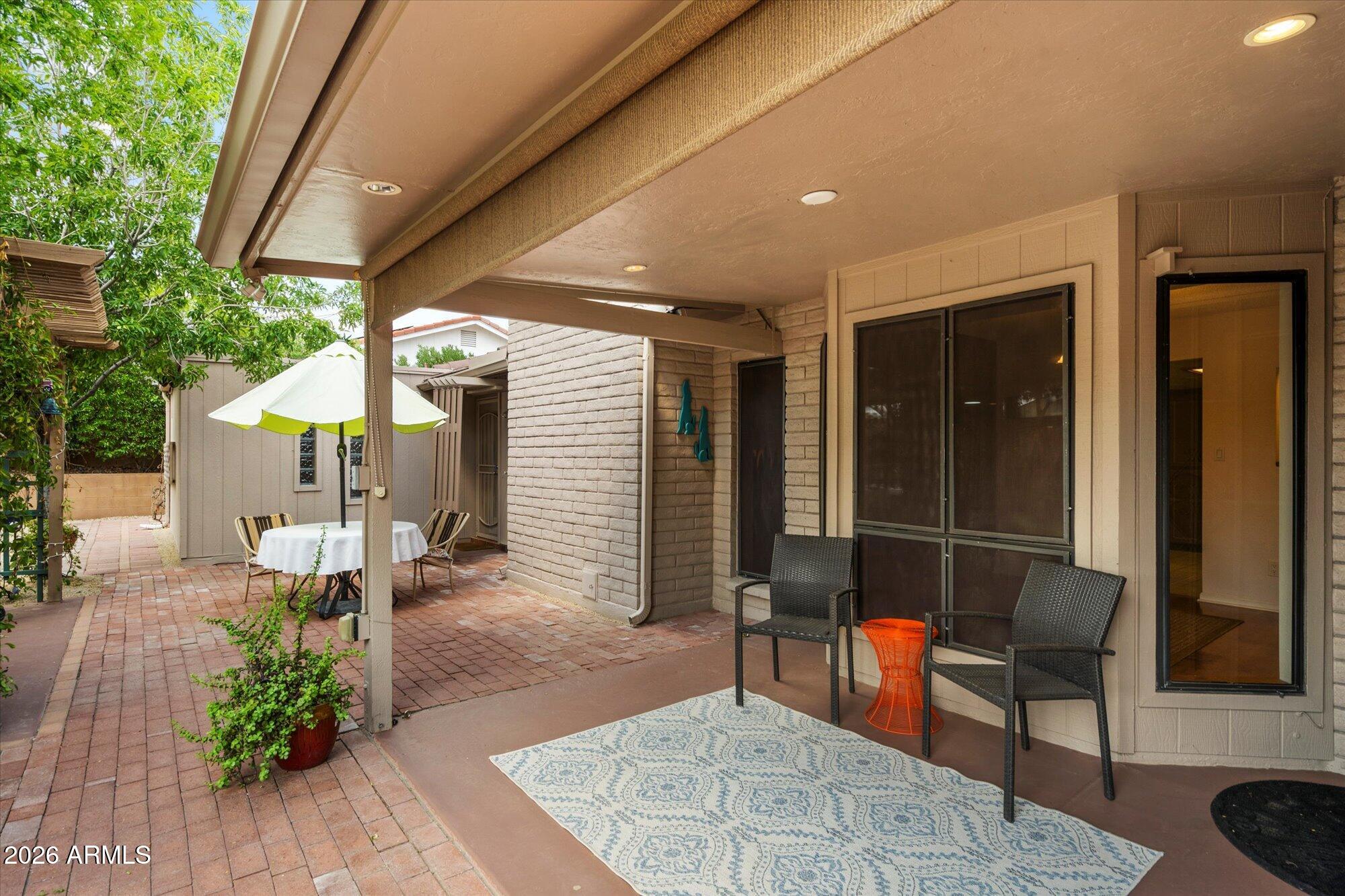 14242 North 9th Street Phoenix, AZ 85022 - Photo 16 of 26 a view of a patio with table and chairs potted plants with wooden floor