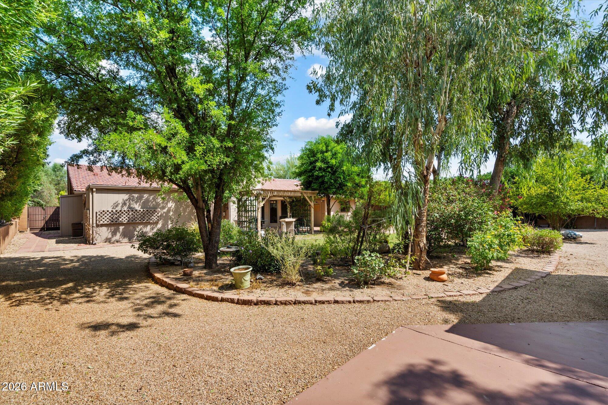 14242 North 9th Street Phoenix, AZ 85022 - Photo 22 of 26 a front view of a house with a yard and tree s