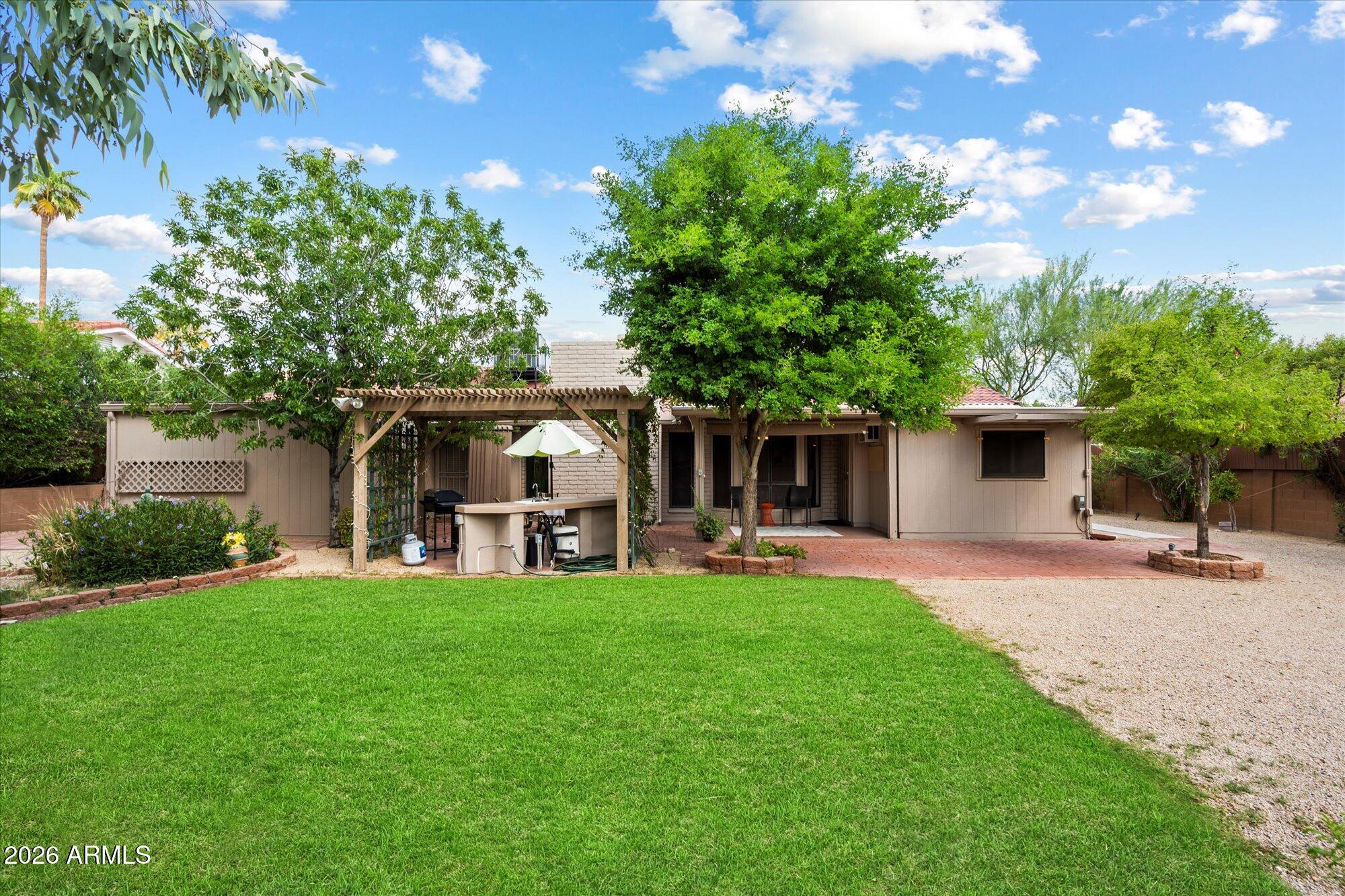 14242 North 9th Street Phoenix, AZ 85022 - Photo 23 of 26 a view of a house with a yard and sitting area