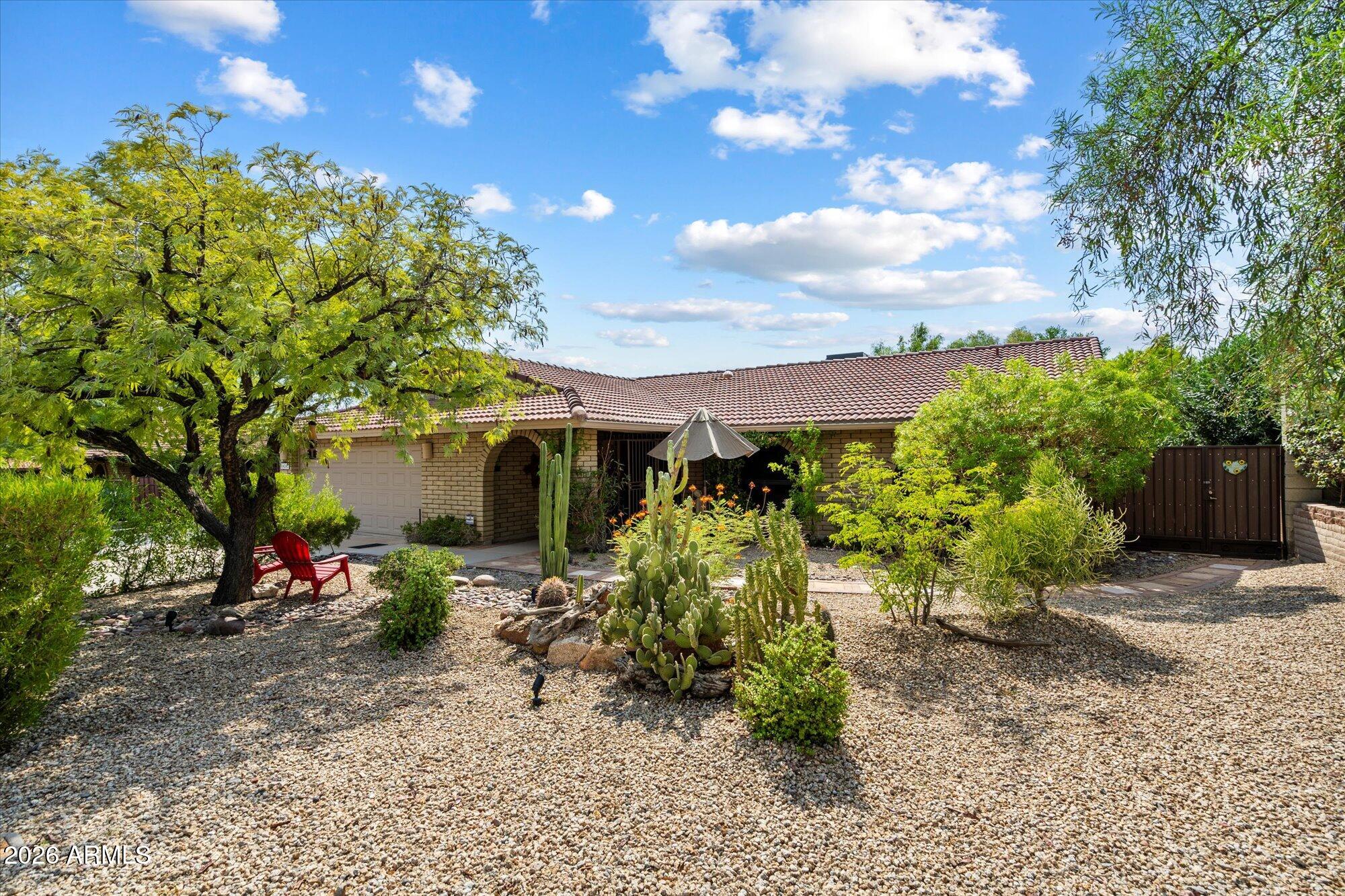 14242 North 9th Street Phoenix, AZ 85022 - Photo 24 of 26 a front view of a house with a yard