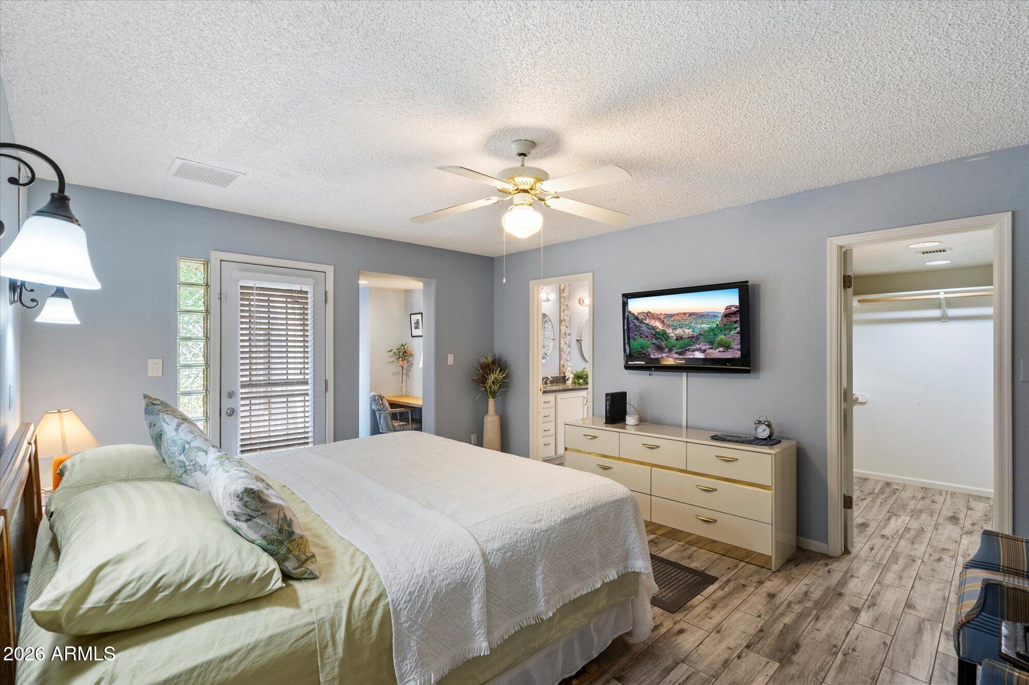 14242 North 9th Street Phoenix, AZ 85022 - Photo 6 of 26 a bedroom with a bed and a chandelier
