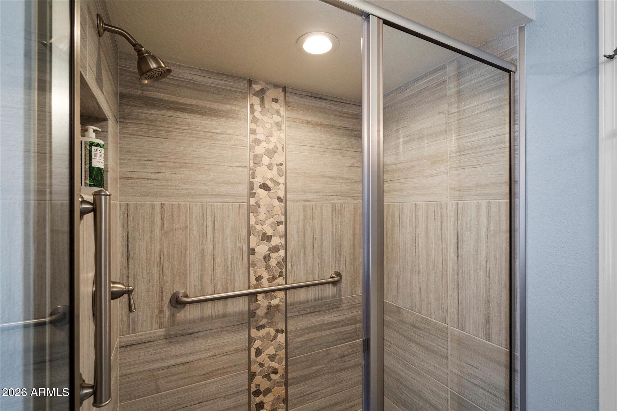 14242 North 9th Street Phoenix, AZ 85022 - Photo 10 of 26 a bathroom with a glass shower door