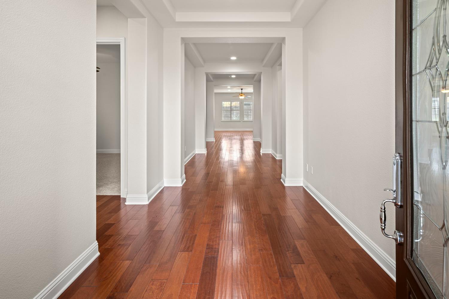 2144 Penstone Loop Roseville, CA 95747 - Photo 18 of 60 a view of a hallway with wooden floor