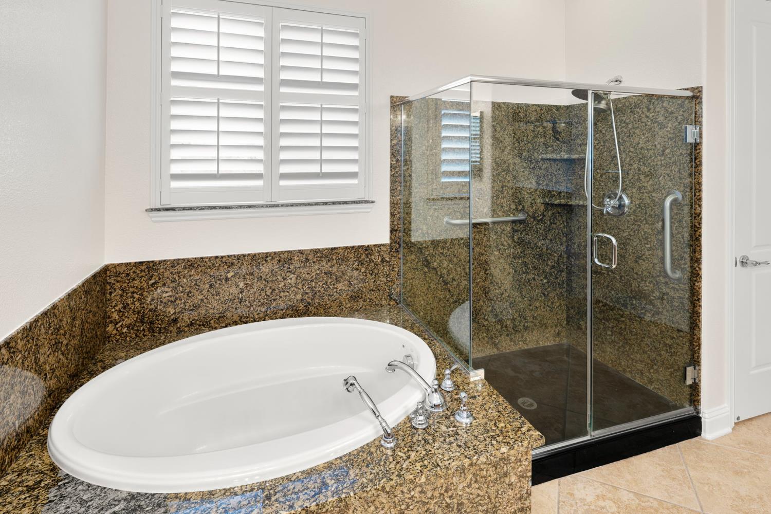 2144 Penstone Loop Roseville, CA 95747 - Photo 38 of 60 a bathroom with a bathtub and shower