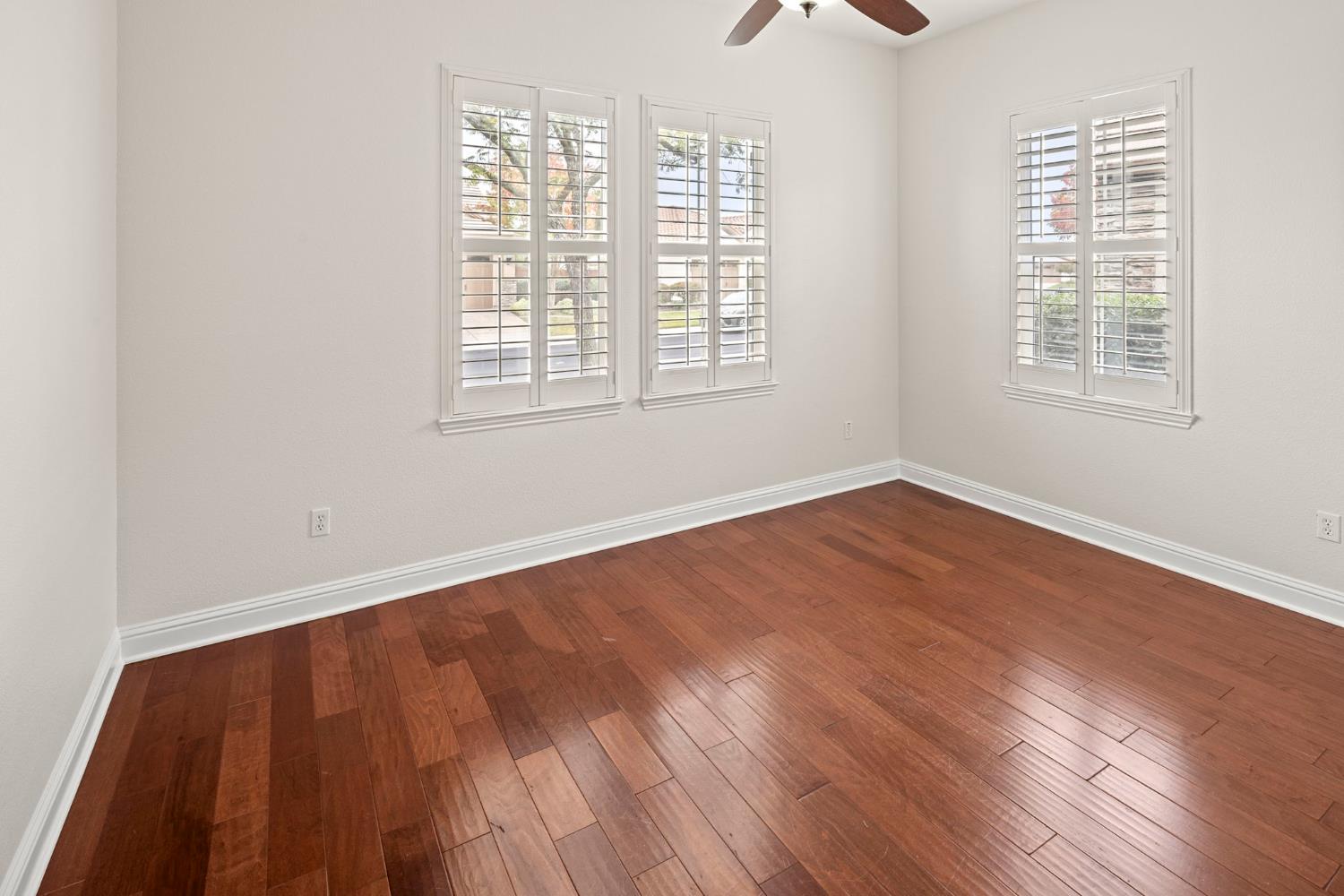 2144 Penstone Loop Roseville, CA 95747 - Photo 40 of 60 an empty room with wooden floor and windows