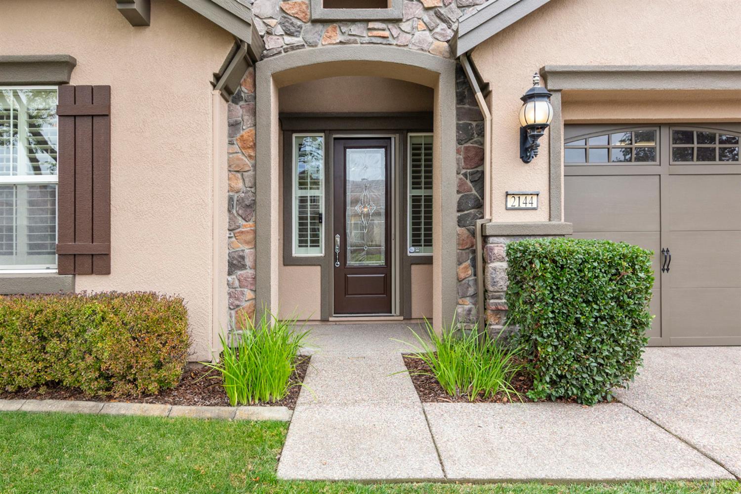 2144 Penstone Loop Roseville, CA 95747 - Photo 4 of 60 a front view of a house with garden