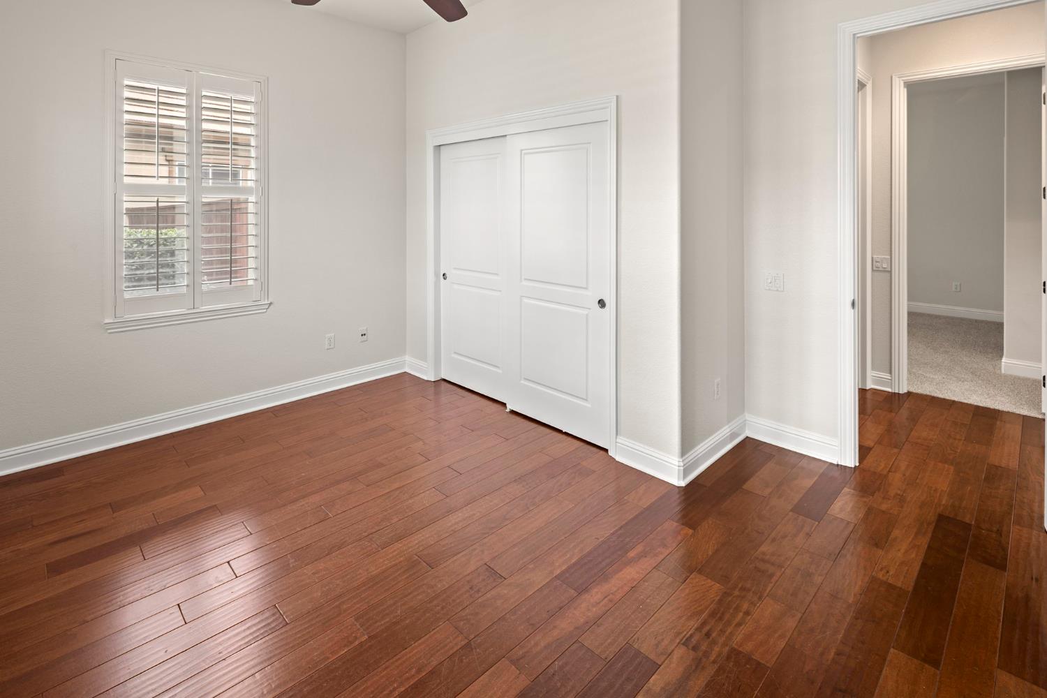 2144 Penstone Loop Roseville, CA 95747 - Photo 41 of 60 an empty room with wooden floor and windows