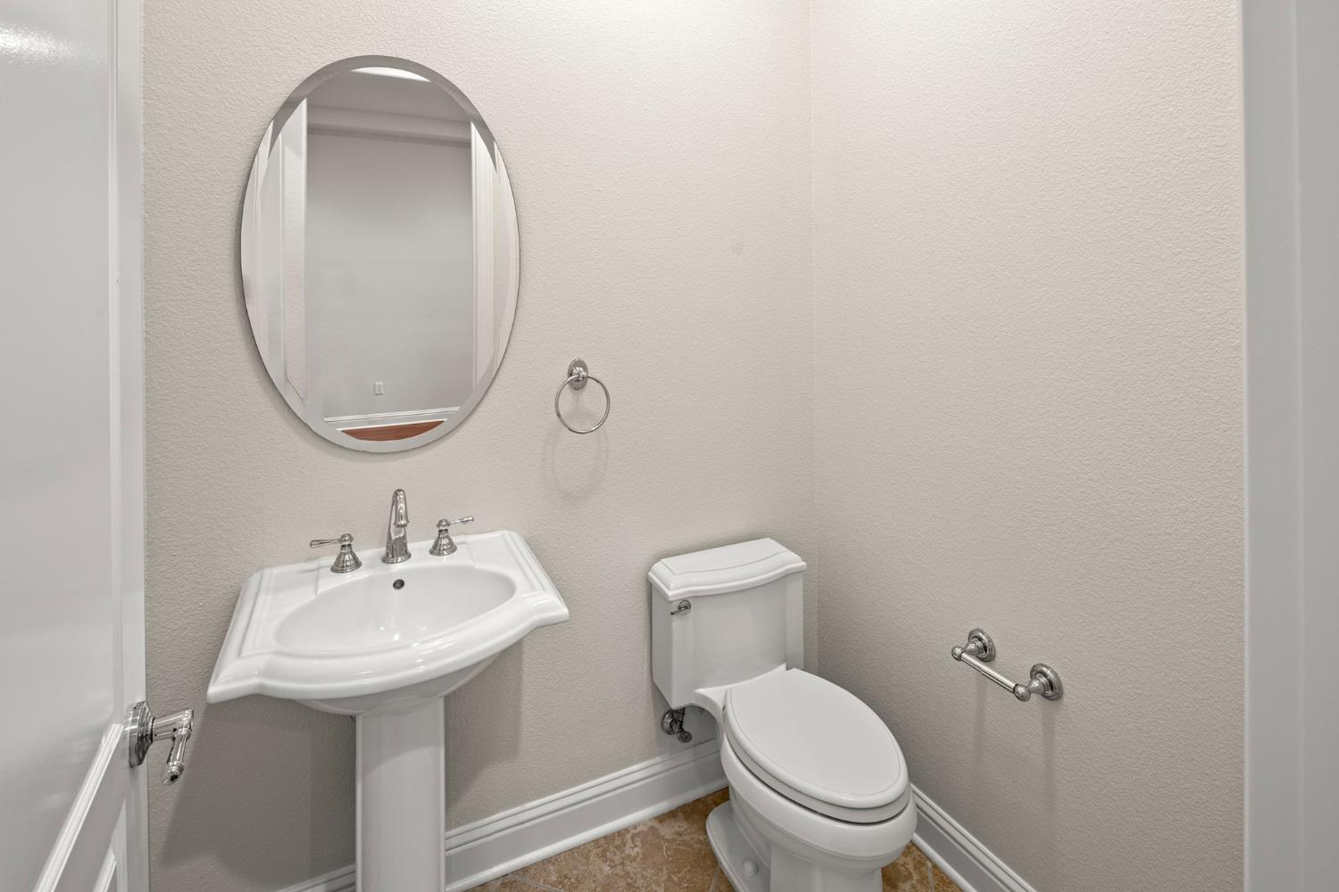 2144 Penstone Loop Roseville, CA 95747 - Photo 45 of 60 a bathroom with a toilet sink and mirror
