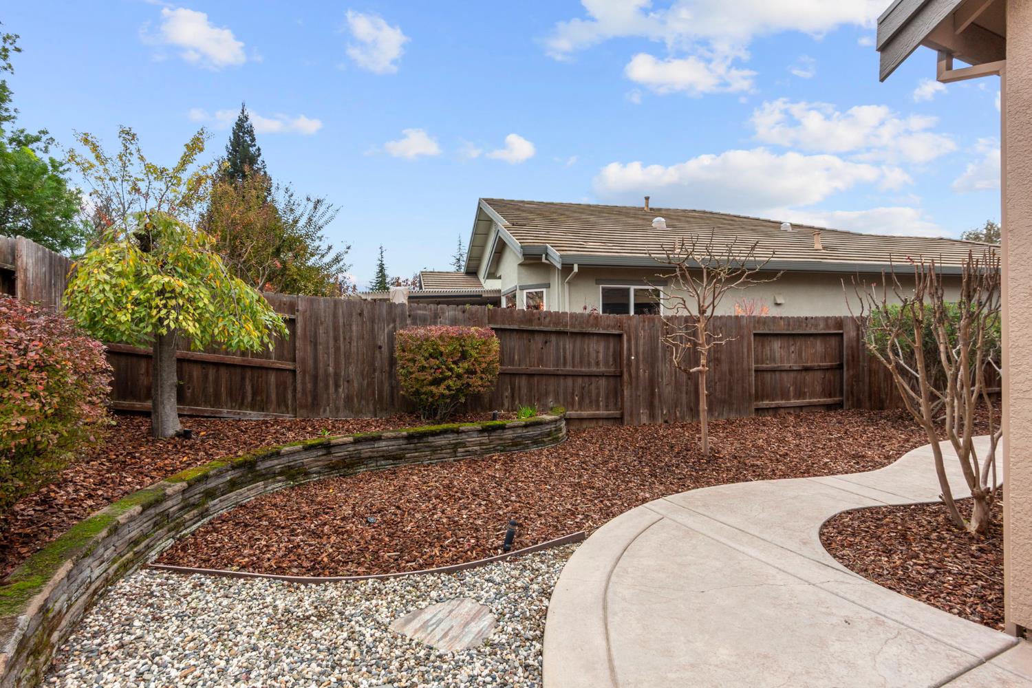 2144 Penstone Loop Roseville, CA 95747 - Photo 51 of 60 a view of a backyard with plants and a patio