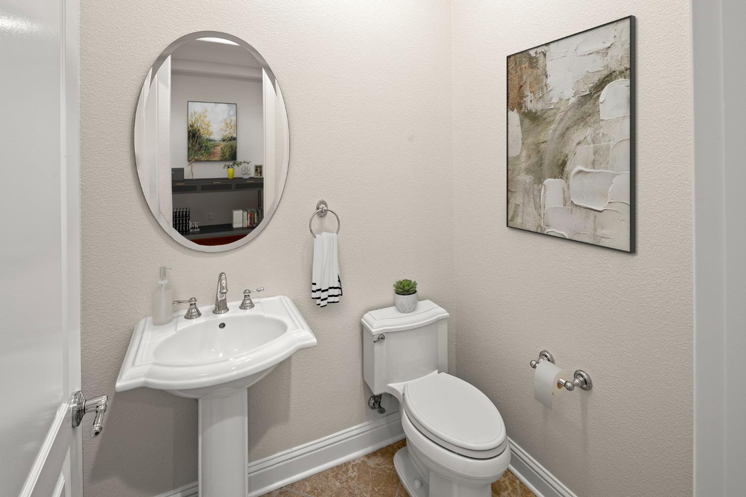 2144 Penstone Loop Roseville, CA 95747 - Photo 9 of 60 a bathroom with a toilet sink and mirror