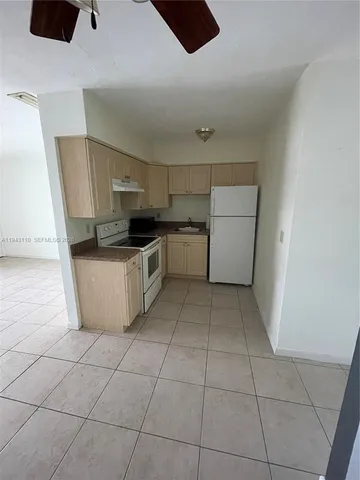 a kitchen with a sink a stove and refrigerator