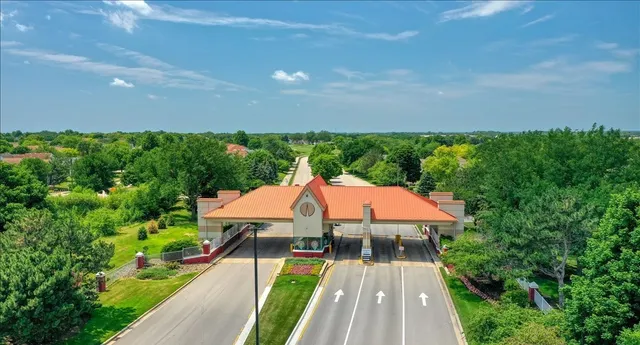 a view of a patio with a table and chairs under an umbrella with wooden floor and fence