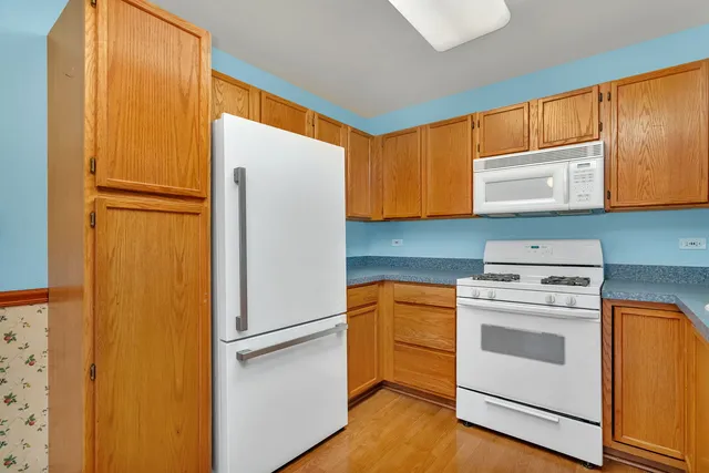 a kitchen with a refrigerator sink stove and cabinets