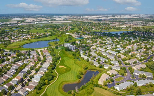 an aerial view of a house with swimming pool patio and outdoor seating