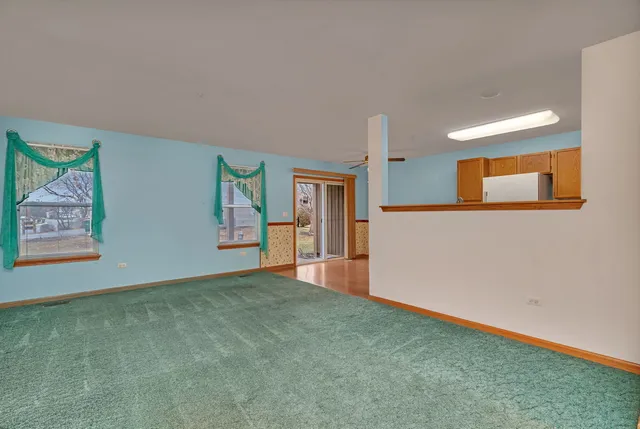 a view of a big room with windows and cabinet