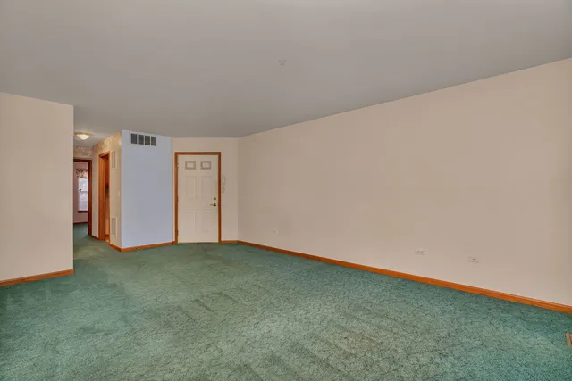 a view of an empty room with closet