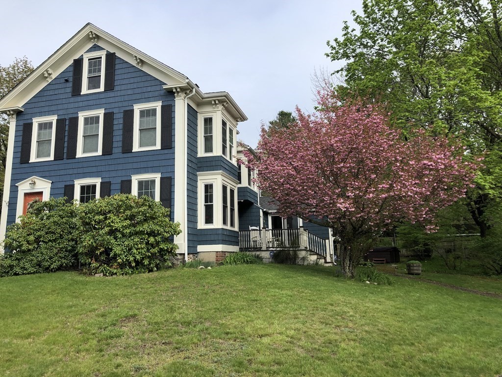 7 Grasshopper Lane Walpole, MA 02081 - Photo 2 of 42 a front view of a house with a garden