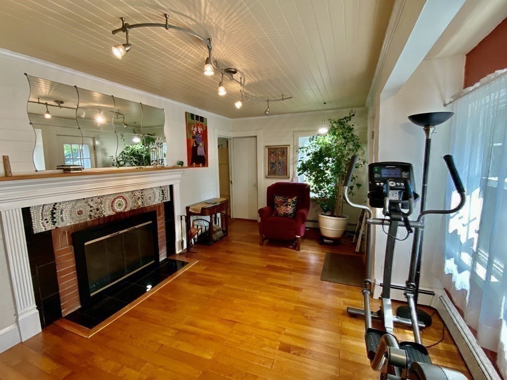7 Grasshopper Lane Walpole, MA 02081 - Photo 21 of 42 a living room with furniture a fireplace and next to a window