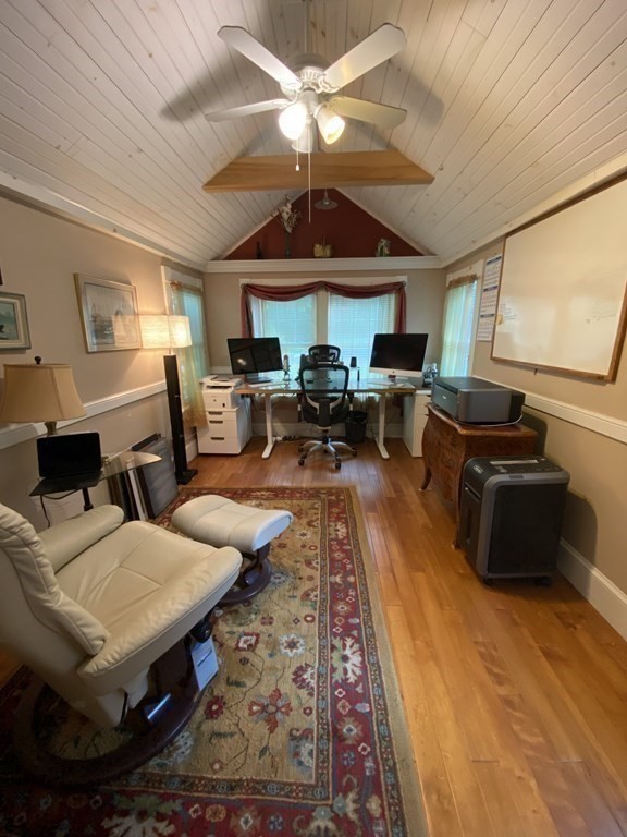 7 Grasshopper Lane Walpole, MA 02081 - Photo 22 of 42 a living room with furniture a chandelier and a fireplace