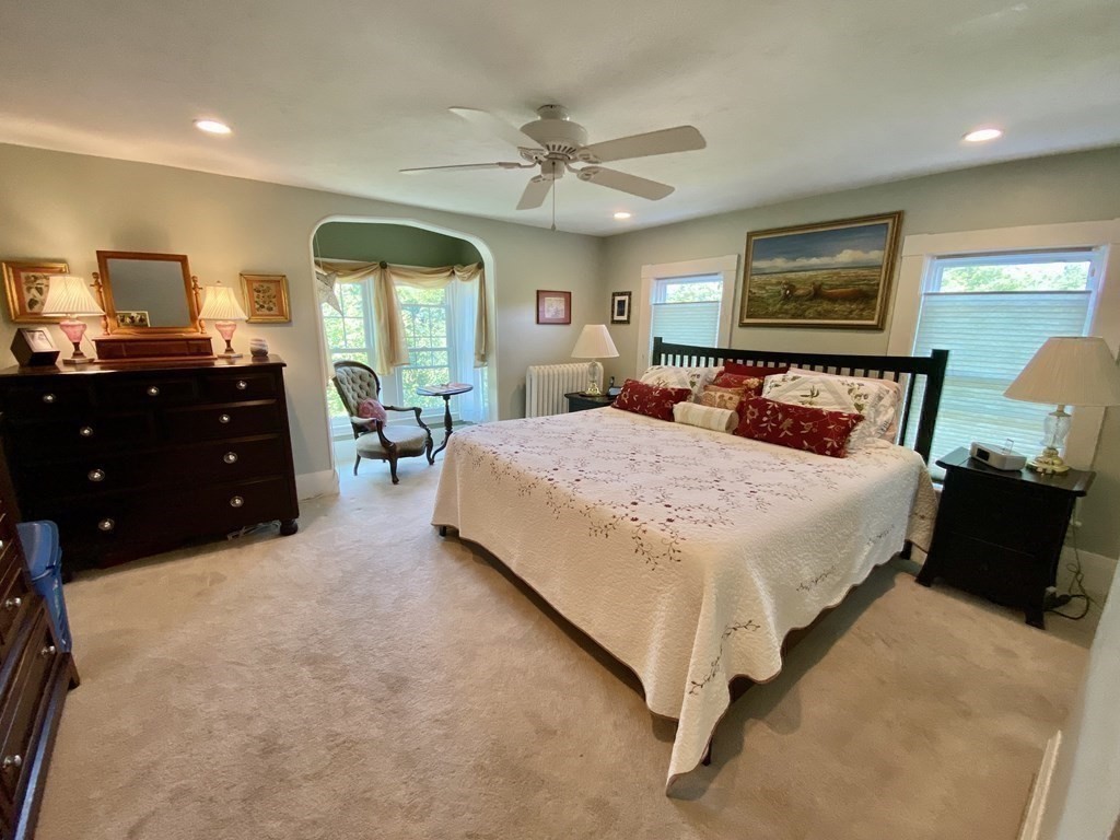 7 Grasshopper Lane Walpole, MA 02081 - Photo 24 of 42 a bedroom with a large bed and a chandelier